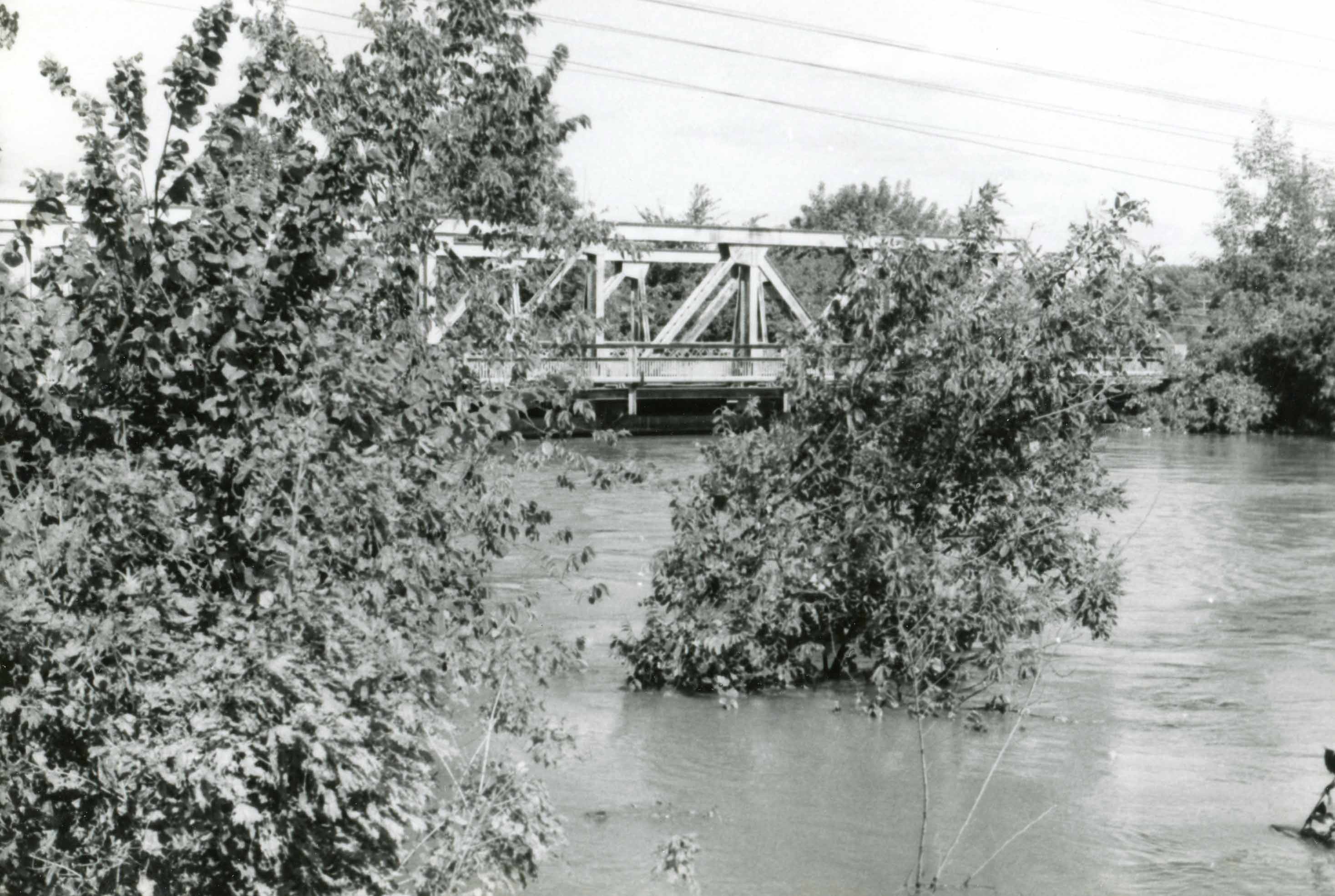 Archival photograph of the Tittabawassee River bridge.